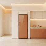 Un réfrigérateur couleur terracotta intégré dans une cuisine minimaliste aux tons beiges et orangés.